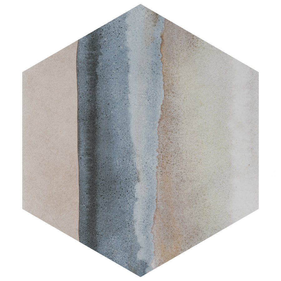 A hexagonal tile with vertical bands of beige, blue-gray, and off-white, featuring a textured, watercolor-like gradient blending between the colors.
