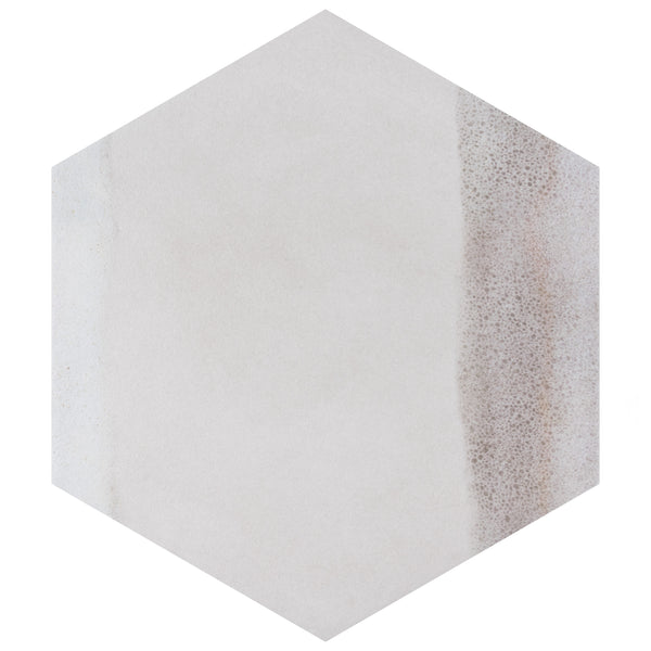 A hexagonal tile with a mostly smooth, light beige surface and a subtle textured brownish area along the right edge.