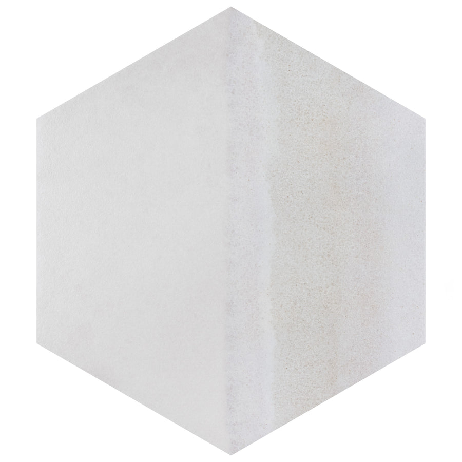 A three-dimensional hexagonal shape with a light, textured surface; the left side is smooth and white, while the right side has a slightly rougher, off-white appearance.