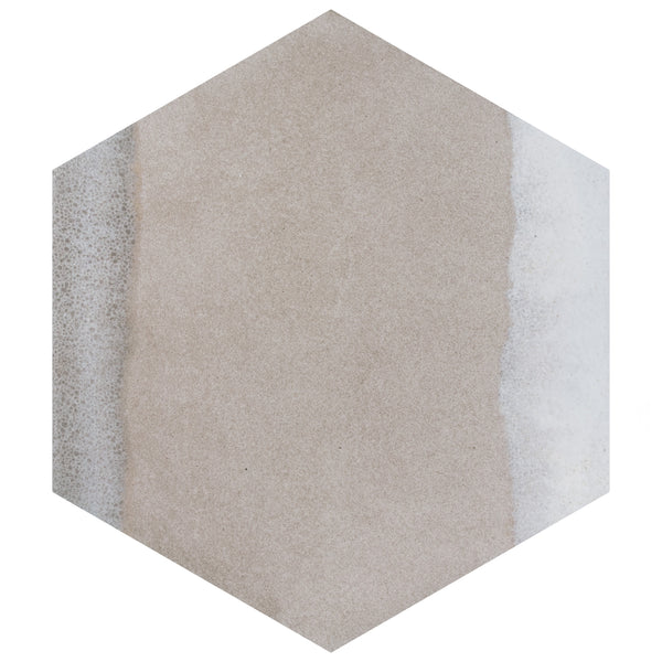 A hexagonal tile with a beige center and irregular white and gray shading along the left and right edges. The surface has a slightly textured, matte appearance.