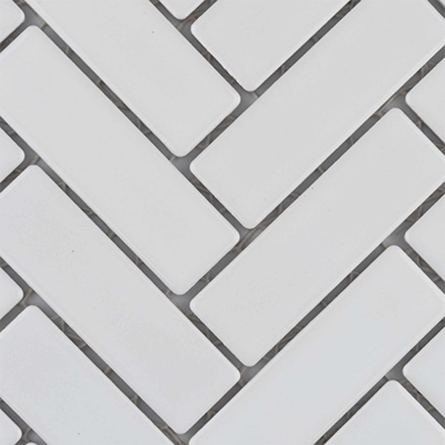 White rectangular tiles arranged in a herringbone pattern, with visible grout lines separating each tile. The tiles have a smooth, glossy finish.
