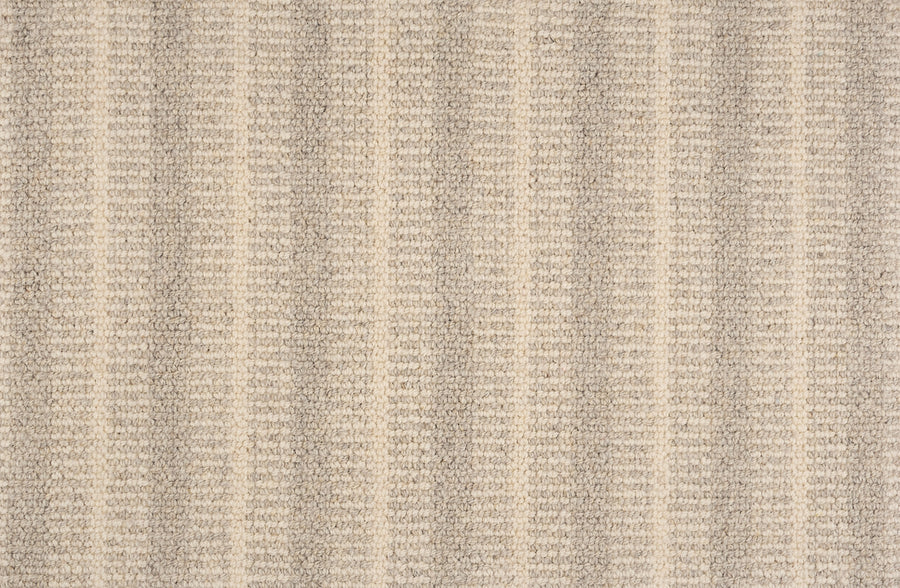 Close-up of the Feng Shui On Trend Carpet in beige, featuring subtle vertical stripes with alternating light and darker textured rows. Its soft, woven surface brings luxurious style to any space.