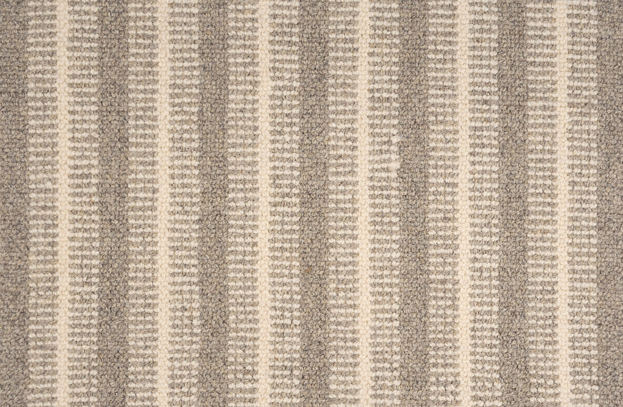 A close-up of the Feng Shui On Trend Carpet showcases its textured, woven fabric with alternating vertical stripes in beige and light brown, creating a subtle and cozy style ideal for luxurious home decor.