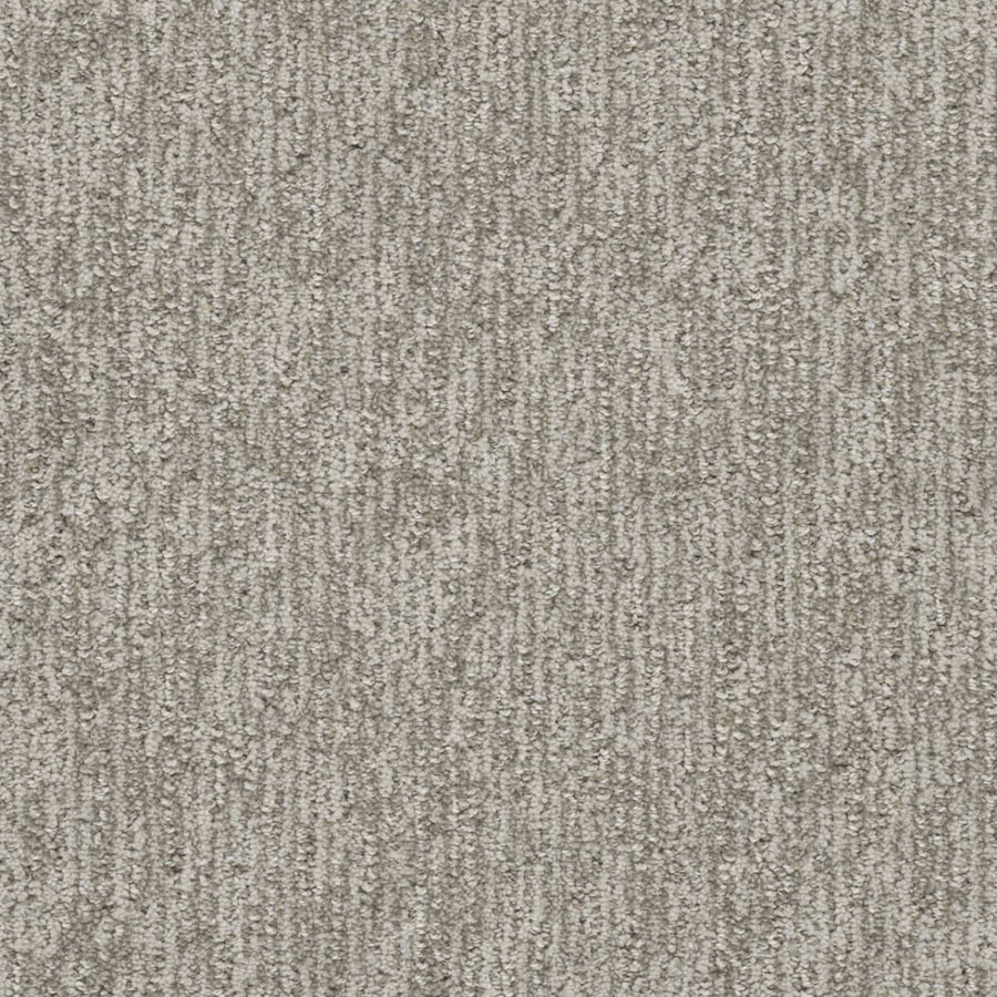 Close-up of the Finishing Touch Berber Carpet in North Star, featuring a textured light gray surface with subtle vertical stripes, designed for high-traffic areas and providing a soft, slightly varied feel.