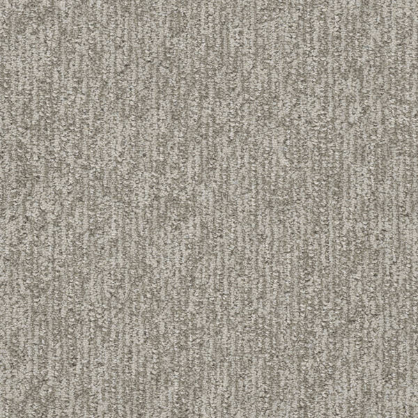 Close-up of the Finishing Touch Berber Carpet in North Star, featuring a textured light gray surface with subtle vertical stripes, designed for high-traffic areas and providing a soft, slightly varied feel.
