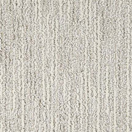Close-up of Advocate Berber Carpet in First Choice color, featuring a light gray, textured looped pile with subtle vertical lines for a soft, durable, and uniform premium berber weave.