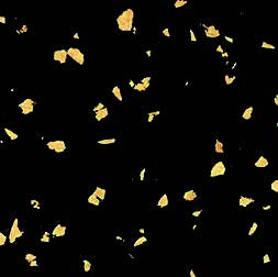Small, irregular yellow-orange flakes are scattered across a solid black background, resembling the accent colors found in premium Fitness Flooring 4x25 High Performance Rubber Roll used in gyms and fitness studios.