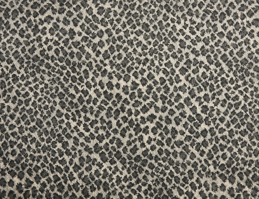 Close-up of Serengeti On Trend Carpet in Flannel, showcasing a black and gray leopard print with irregular dark spots on a light background—perfect for adding contemporary style and the look of animal fur to quality flooring.