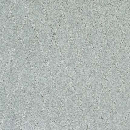 The Absolute Berber Carpet in Flawless features a light gray, textured surface with a subtle, repeating diamond pattern—soft and slightly raised for an elegant look, yet durable enough for high-traffic areas.