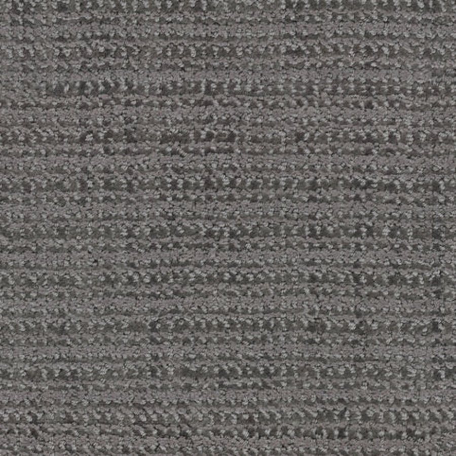 Close-up of Beguiling Berber Carpet in Flint—textured gray with a subtle horizontal linear pattern. The soft, slightly raised surface displays varied gray shades throughout.
