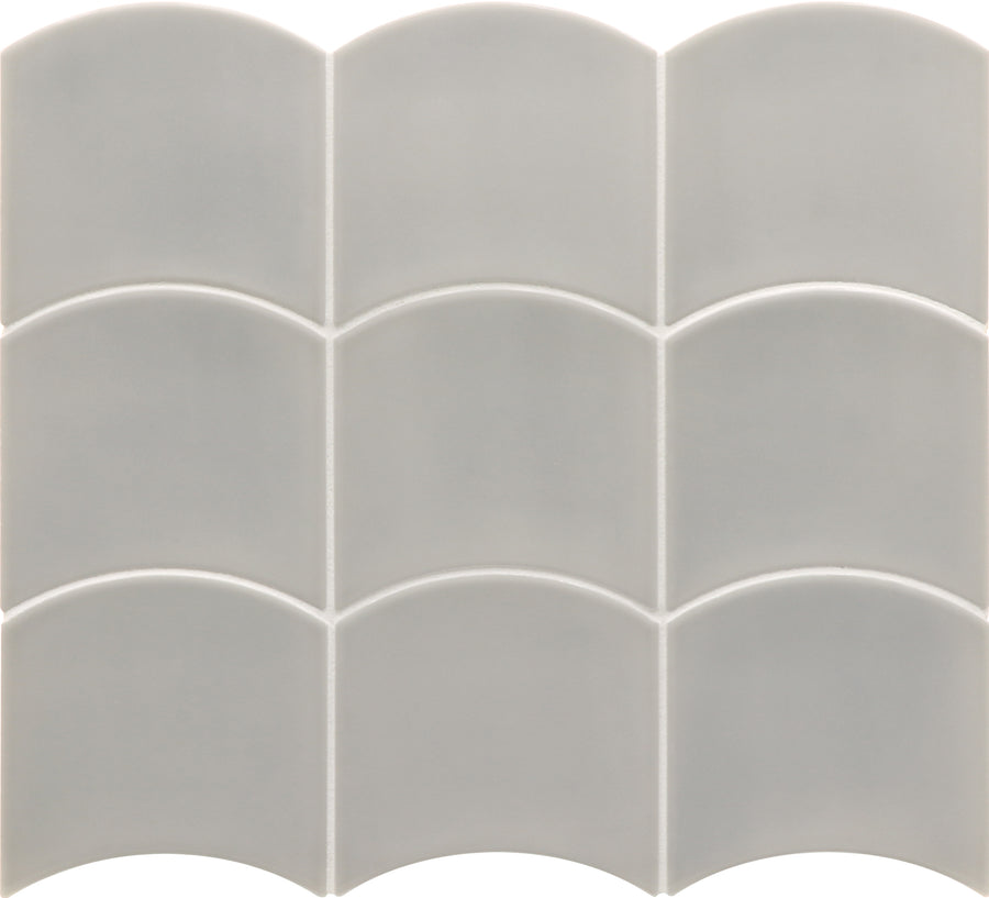 The Flow Motion 5x5 Glazed Ceramic Tile set includes nine light gray tiles, each uniquely shaped with a scalloped top edge, arranged in a 3x3 grid to form a repeating wave pattern.