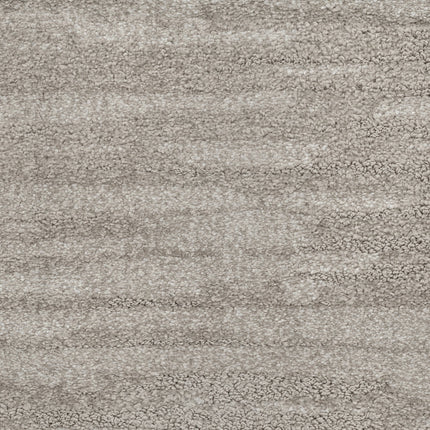 Close-up of Cirrus Berber Carpet in Fog—a textured, light gray luxury carpet with soft, plush fibers and subtle shading variations. Its cozy, inviting surface is ideal for premium flooring.