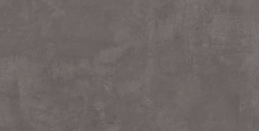 The Forge 24x48 Rectified Porcelain Tile features a textured dark gray finish with subtle color variations, delivering a sleek, contemporary look that mimics the appeal of concrete.