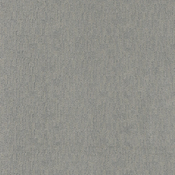 A close-up of Sneak Peak Berber Carpet in Fresh Tone shows its textured, light gray surface with a subtle linear pattern. The dense pile offers both softness and durability, highlighting slight shade and texture variations.