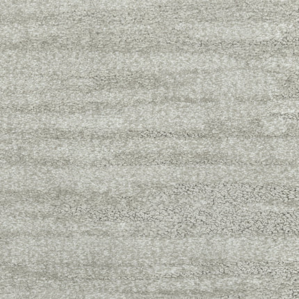 Close-up of Cirrus Berber Carpet in Frost—a light gray, softly mottled carpet with subtle horizontal shading and textured detail, ideal for adding premium flooring to any space.