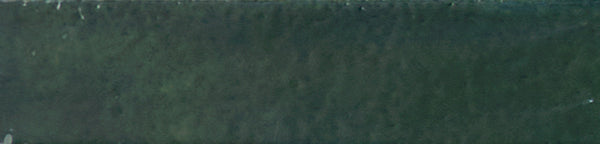 A close-up of the Galaxy 2x10 Porcelain Tile reveals its dark green glaze, slightly uneven surface, and subtle color variations—ideal for luxury tiling.