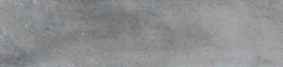 A close-up view of the Galaxy 2x10 Porcelain Tile reveals a gray, glazed surface with a slightly rough texture and subtle shading, creating an elegant, luxurious tile look.