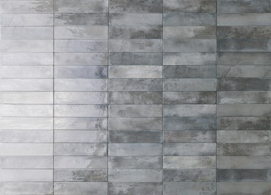 Rectangular gray tiles arranged in a horizontal grid pattern, with a slightly reflective surface and various shades of gray creating a textured, modern look.