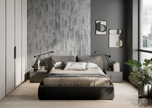 Modern bedroom with a gray textured accent wall, minimalistic furniture, a large bed with neutral bedding, bedside lamps, abstract artwork, potted plant, and large windows with a city view.
