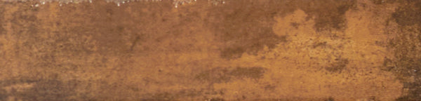 A close-up of the Galaxy 2x10 Porcelain Tile reveals a rusty, textured metal look in brown and orange tones with dark patches, capturing the unique industrial aesthetic of weathered luxury tiling.