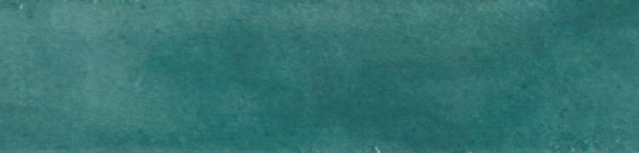 The Galaxy 2x10 Porcelain Tile features a smooth, mottled teal surface with subtle color and texture variations, creating a slightly weathered look that’s perfect for luxury tiling.