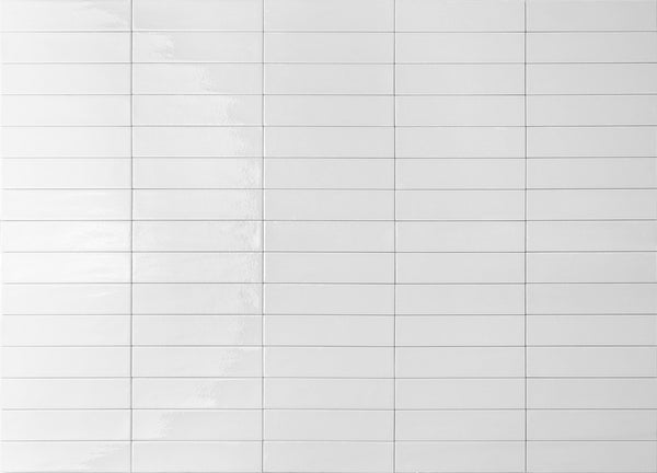 A grid of glossy white rectangular tiles arranged in rows and columns, with visible grout lines between each tile. The surface reflects light, creating subtle highlights and a clean, minimalistic appearance.