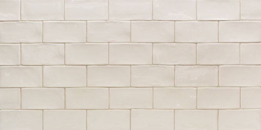 The Masia 3" x 6" Subway Tile in Ivory, arranged in a staggered brick pattern, creates a clean and simple look for kitchen backsplashes or wall surfaces.