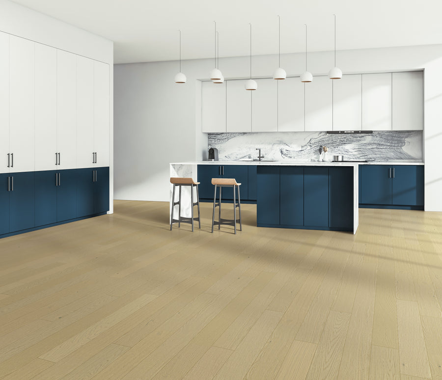 Modern kitchen with blue and white cabinets, a marble-patterned backsplash, light wood flooring, an island with two barstools, and five pendant lights hanging above the island.
