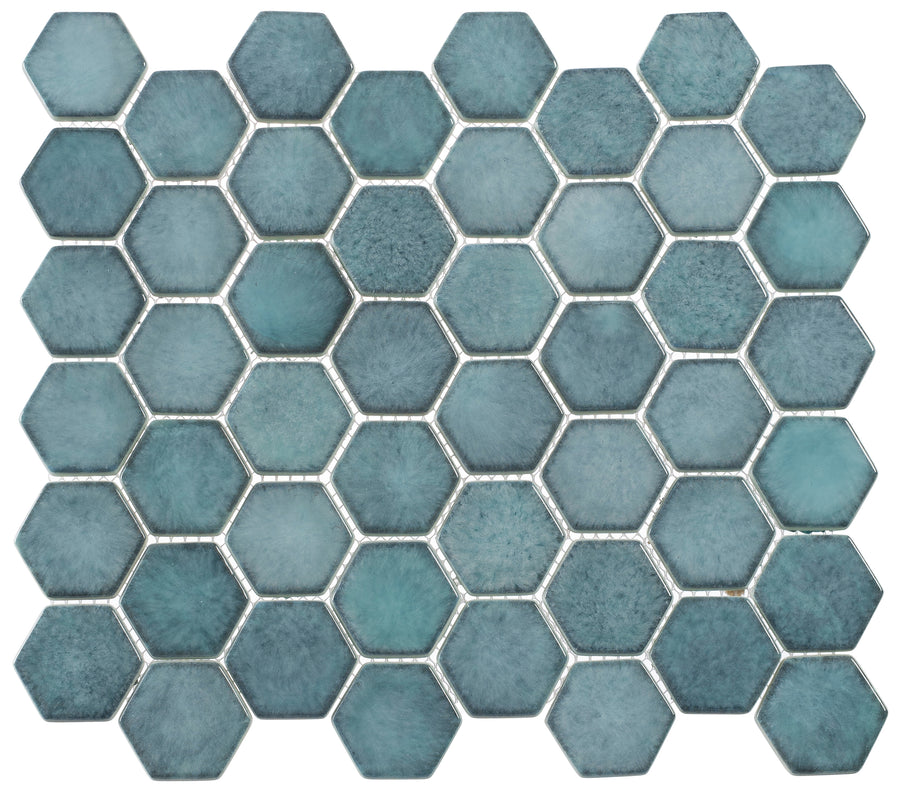 A grid of Greenwich 2" Hexagon Glass Mosaic Tiles in Historic Grand, featuring a honeycomb pattern and separated by thin white grout lines for a modern look.