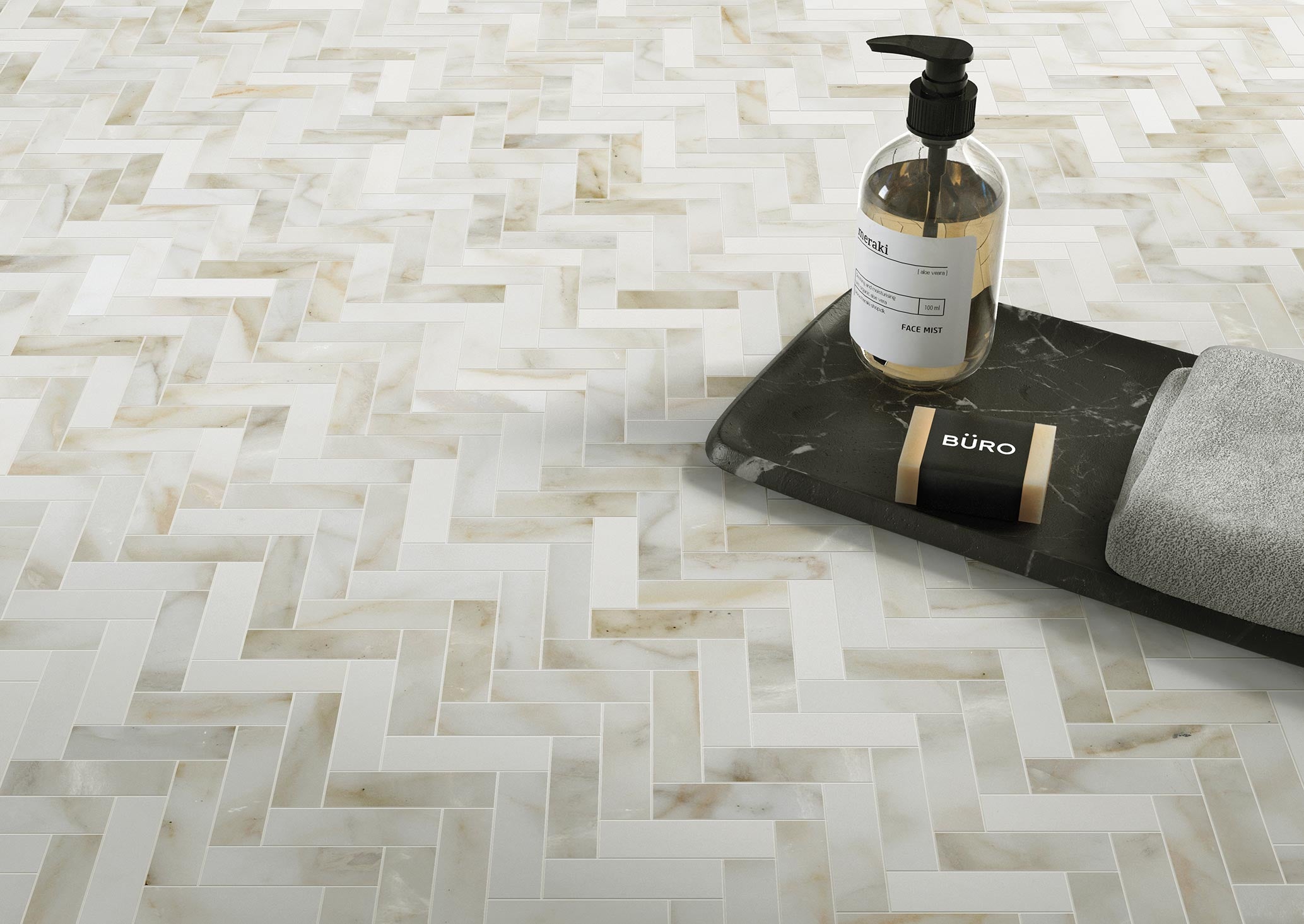 
		                            	Palazzo 1x3 Herringbone Tile in white and beige shades, styled with a dark tray holding a soap dispenser, a bar of soap, and a gray cloth.
		                            