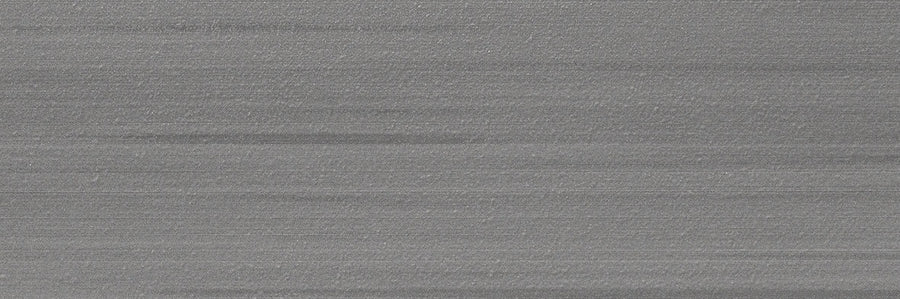 A close-up of the Met 4x12 Porcelain Tile reveals its silvery-grey brushed metal look with horizontal lines, subtle textures, and gradients—ideal for modern spaces embracing contemporary design trends.