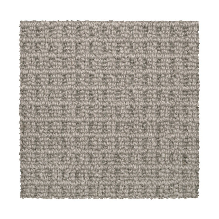A square sample of Glen Abbey II Berber Carpet in Mushroom, featuring textured gray tones and a subtle basket-weave pattern, is displayed elegantly on a white background.
