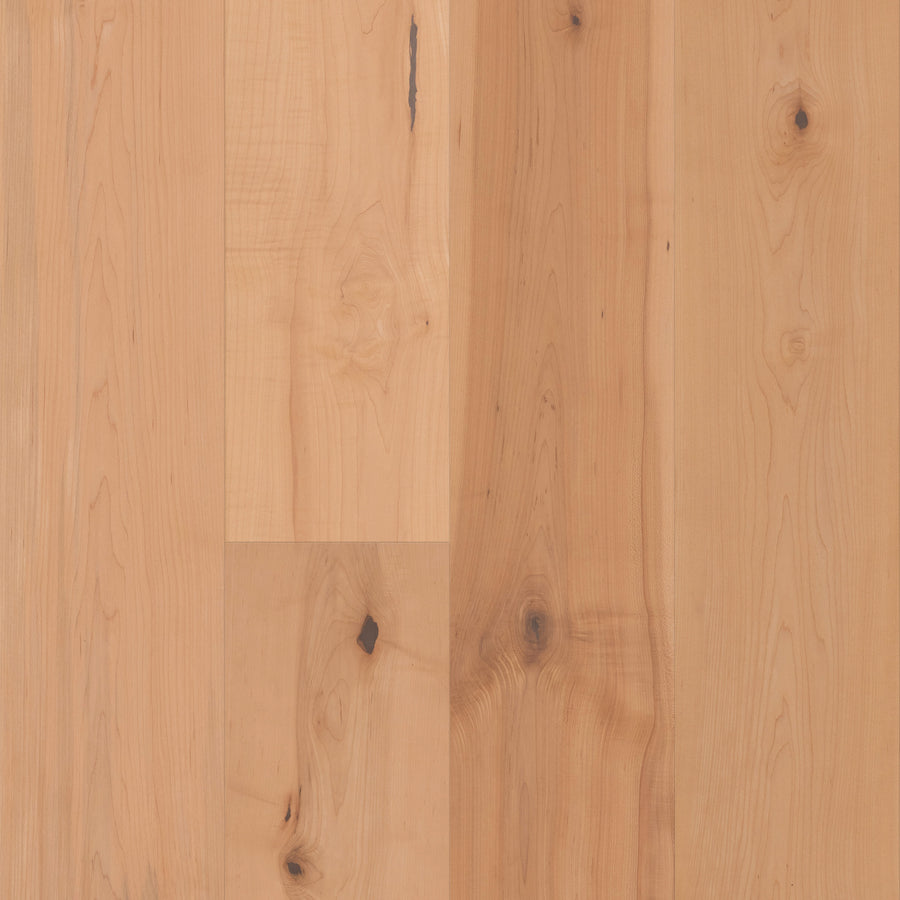 Gran Reserva 7 1/2" Hardwood in Natural offers luxury flooring with 7 1/2" wide planks showcasing visible wood grain, knots, and subtle natural imperfections, all finished with a smooth, polished surface.