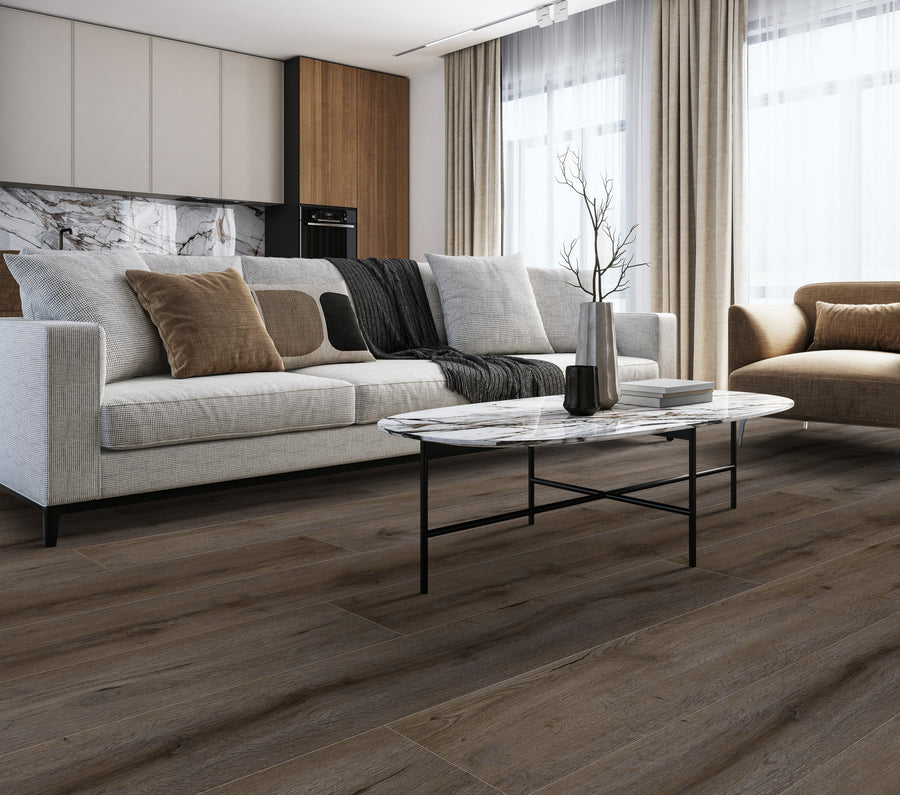 Modern living room with a light gray sofa, neutral cushions, a marble coffee table with a vase, an armchair, wood flooring, large windows with beige curtains, and minimalist decor.