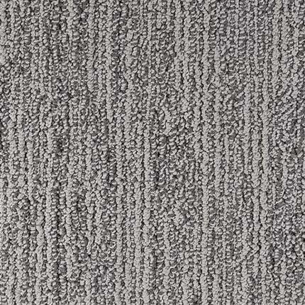 Close-up of Advocate Berber Carpet in Grand Prize color, featuring textured gray looped fibers arranged in a subtle vertical linear pattern.