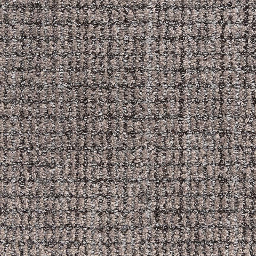 Close-up view of Aspen Berber Carpet in Graphite, featuring a looped, grid-like pattern. Its durable fibers give the surface a subtle checkered look.