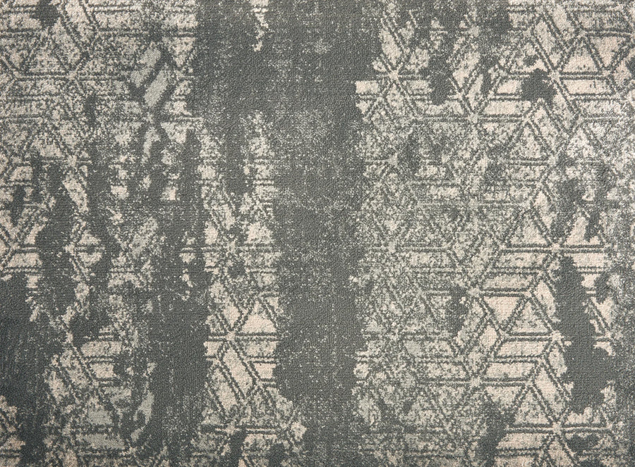 The Delphi On Trend Carpet in Graphite features a geometric hexagon pattern with distressed, vintage-style areas in gray tones—perfect for adding elegant appeal to both residential and commercial floors.