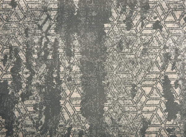 The Delphi On Trend Carpet in Graphite features a geometric hexagon pattern with distressed, vintage-style areas in gray tones—perfect for adding elegant appeal to both residential and commercial floors.