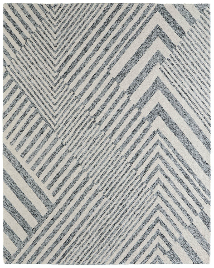 The Wallace 8A42F Area Rug features a modern geometric pattern with diagonal gray lines forming triangles and diamonds on a white background, adding dynamic style and interest to any living space.