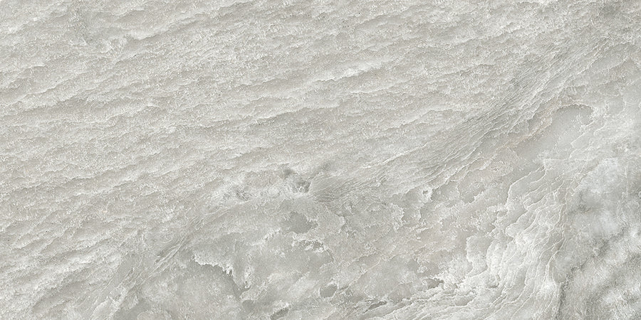 A close-up of the Amazonia 24x48 Glazed Porcelain Tile in light gray, featuring subtle waves and layered patterns resembling natural marble or Brazilian Slate.