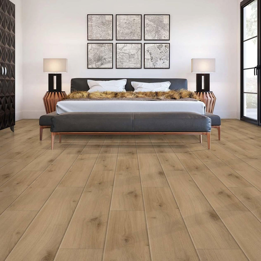 A modern bedroom with light wood flooring, a large bed with fur pillows, two lamps on wooden nightstands, wall art above the bed, and large windows letting in natural light.