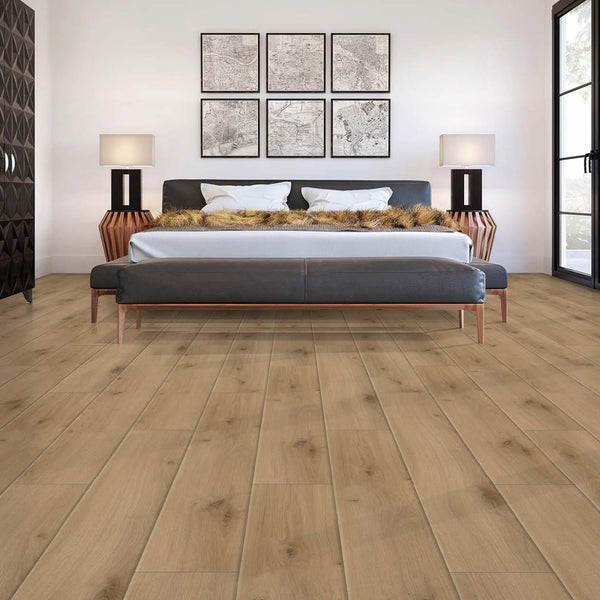 A modern bedroom with light wood flooring, a large bed with fur pillows, two lamps on wooden nightstands, wall art above the bed, and large windows letting in natural light.