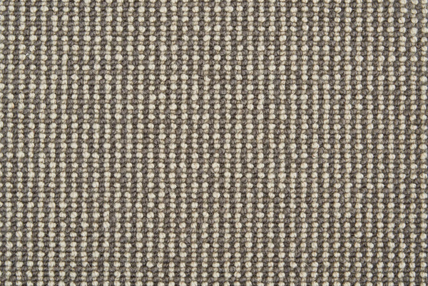 Close-up of Harper Berber Carpet in Gun Metal, showing a textured woven pattern with alternating beige and gray threads for a grid-like, durable surface—blending everyday resilience with timeless style.