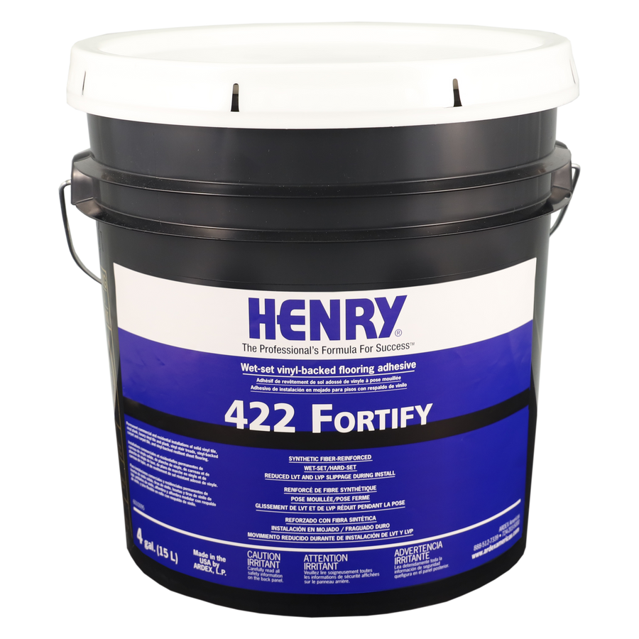 A large black and white plastic bucket labeled Henry 422 high-strength wet-set adhesive for vinyl-backed flooring, featuring product details and safety information printed on the front.