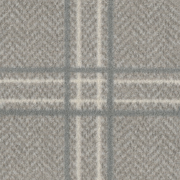 A close-up of Herrington On Trend Carpet in Quartz shows its textured grey herringbone fabric with intersecting plaid lines, perfect for contemporary spaces and high-traffic areas.