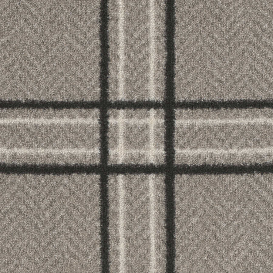 A close-up of Herrington On Trend Carpet in Blackwed shows grey fabric with a plaid pattern, thick black and thin white lines forming large squares, and a subtle herringbone design—perfect for contemporary, high-traffic luxury spaces.