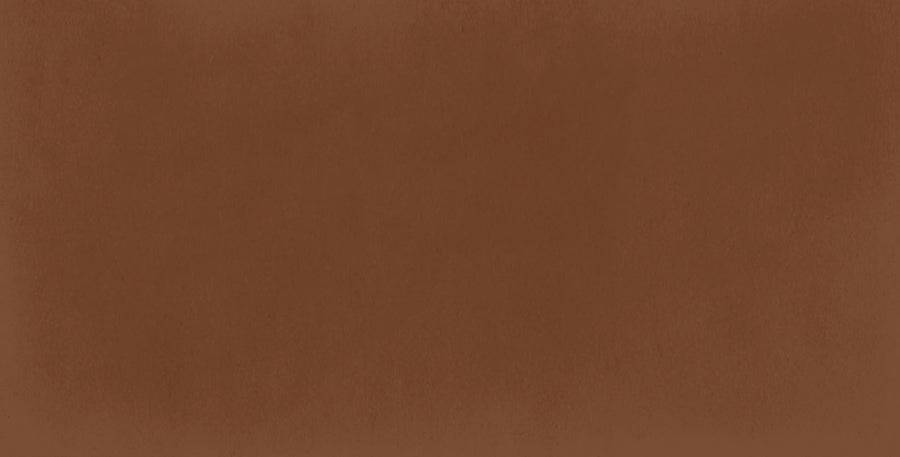 The Harmony 2.5x5 Porcelain Tile features a medium brown, solid textured background with a soft matte finish and subtle shading for a natural, handmade tile look.