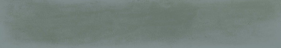 The Harmony 2.5x15 Porcelain Tile features a textured, faded green surface with subtle, uneven patterns, capturing artisanal craftsmanship and vintage charm through its muted color and handmade tile appearance.