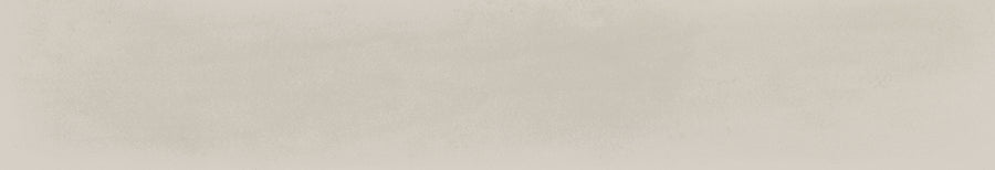 A textured, off-white background with subtle grayish tones and a slightly grainy appearance, reminiscent of the surface of the Harmony 2.5x15 Porcelain Tile. No distinct objects or features are visible.