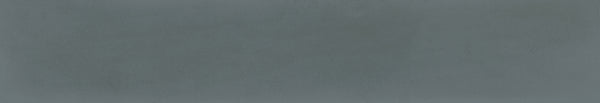 The Harmony 2.5x15 Porcelain Tile features a textured, solid blue-gray background with subtle shade variations, resembling handcrafted tile or concrete.